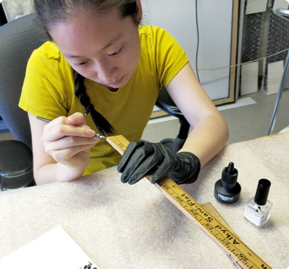Photo of a woman restoring a ruler