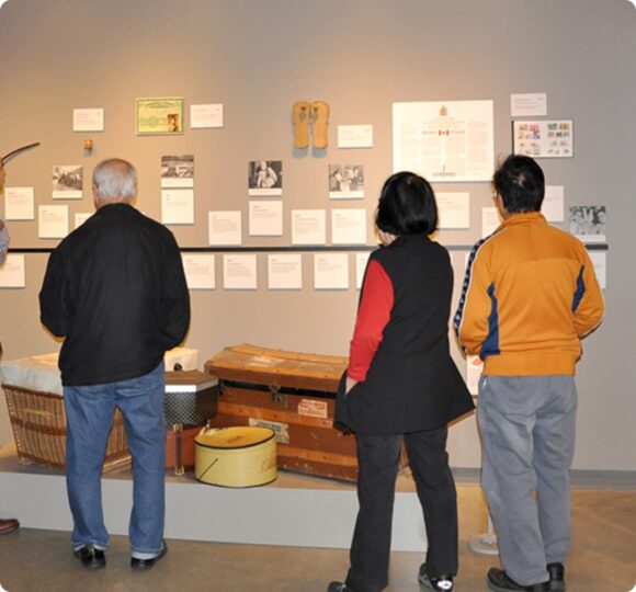 Photo of three visitors looking at the exhibition