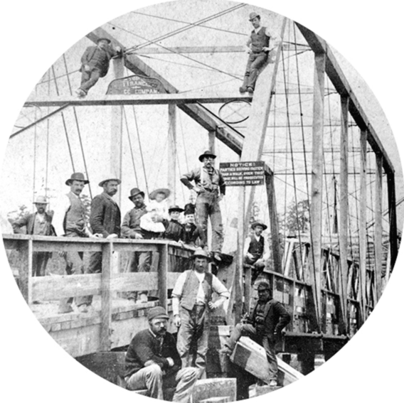 Photo of men and women standing and climbing on a bridge