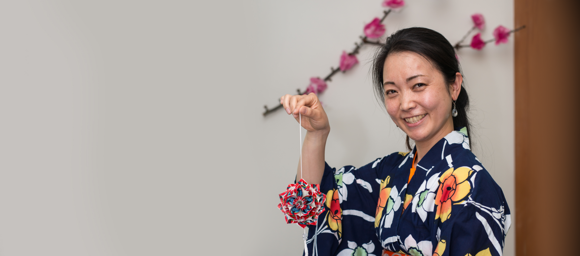 A woman wearing Kimono holding a origami